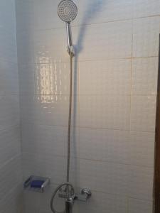 a shower with a shower head in a bathroom at Studio meublé à Bel Air in Dakar