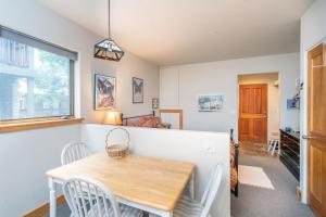 a dining room with a wooden table and chairs at Cozy Tomboy Studio with private deck in Telluride