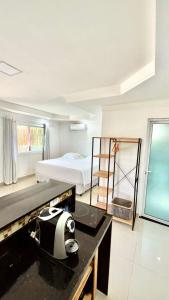a bedroom with a bed and a desk in a room at Terras Verdes Residence in Fernando de Noronha +23 photos