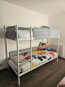 two bunk beds in a small room with at Appart 3 chambres-Gare 1 min-Disneyland Paris 6 min in Bussy-Saint-Georges