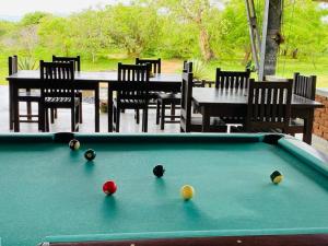 a pool table with balls on top of it at Yala Ying Yang Hostel & Camping in Yala