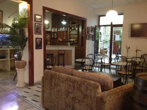 a living room with a couch and tables and chairs at Hotel Nova Centro in Jerez de la Frontera
