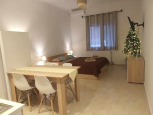 um quarto com uma cama e uma árvore de Natal em Studio Gaia em Volos