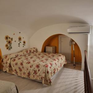 um quarto com uma cama com colcha floral em Napoli Charme em Nápoles