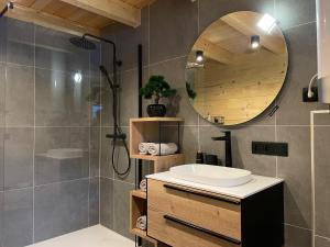 a bathroom with a sink and a mirror at Radovna Chalet with Panoramic View in Mojstrana