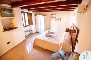 a bedroom with a bed with a teddy bear on it at Manno 81 - Charming historic apartment in Cagliari