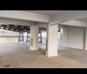an empty room with white columns in a building at Central appartment 2 with parking in Larisa