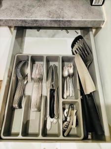 a tray filled with utensils on a counter top at Dream Dwell Paris-Chic flat in the heart of Marais near Pompidou Centre in Paris