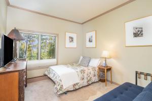 a bedroom with a bed and a window at Ski in Ski out Village Creek condo in the Mountain Village Core in Telluride