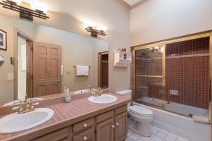 a bathroom with two sinks and a toilet at Ski in Ski out Village Creek condo in the Mountain Village Core in Telluride