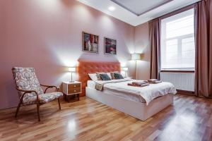 リヴィウにあるStylish Apartment - Ivana Franka Streetのベッドルーム1室(ベッド1台、椅子、窓付)