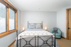 a bedroom with a bed and a window at Ski in ski out Terraces Condo in Telluride