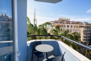 a balcony with a table and a view of a city at Comfort Suites in Alanya