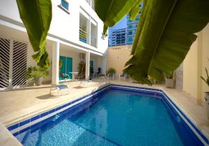 a swimming pool in the middle of a building at Charme 64 Hotel Boutique in Cartagena de Indias