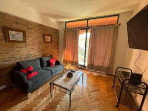 a living room with a couch and a table at Beautiful apartment in Puerto Madero in Buenos Aires