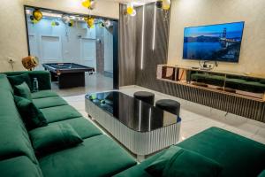 a living room with a couch and a pool table at Rosset-57, Cosy Stay & luxury party place in Faridabad