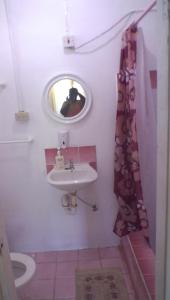 a bathroom with a sink and a mirror at Maracas Bay View in Maracas Bay Village