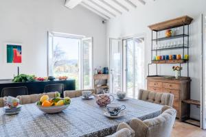 a dining room with a table with a bowl of fruit on it at CASALE ORTALI - Miani Group in Pesciano