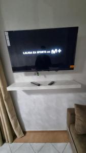 a flat screen tv hanging on a wall at Apartamento Vista Mar in Martil
