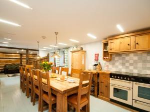 a kitchen with a wooden table and chairs at 3 Bed in York 37257 in Fangfoss