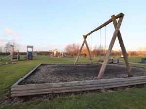 a swing set in a park with a playground at 3 Bed in York 37257 in Fangfoss