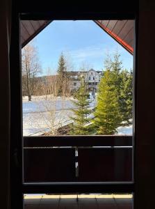 a window with a view of a snow covered field at Apartmán Bílé Labe in Špindlerův Mlýn