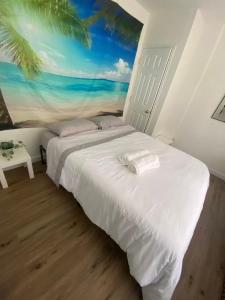 a bedroom with a bed with a painting of the ocean at Peaceful House near Manhattan in Queens