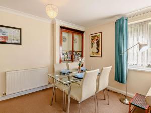 a dining room with a glass table and white chairs at 2 Bed in Sawmills PK934 in Whatstandwell