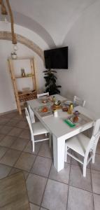 a white table and chairs with food on it at MI PUGLIA Casa vacanze in Putignano
