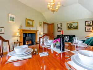 a dining room table with glasses and a bottle of wine at 2 Bed in St Andrews 45668 in Ladybank
