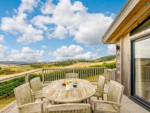 a patio with a table and chairs on a balcony at 3 Bed in St Andrews 88545 in Balmullo