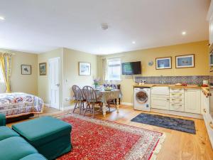 a living room with a blue couch and a table at 1 Bed in Bonar Bridge 89058 in Culrain