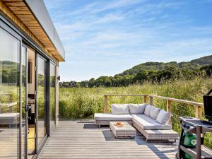 a deck with a couch and a table at 1 Bed in Worcestershire 89032 in Abberley