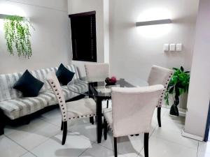 a living room with a table and chairs and a couch at Umhlanga Gateway Apartments in Durban