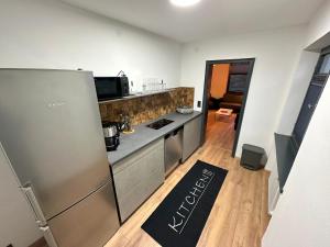 a kitchen with a refrigerator and a counter top at FeWo Grünten in Sonthofen