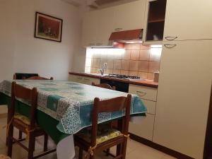 a kitchen with a table and a refrigerator at SANT'ALESSIO_BAY in Santa Margherita-Sant'Alessio Siculo +7 photos