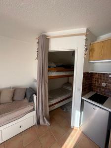 a small room with a bed in a kitchen at Le shuss 4 la foux d'allos in La Foux
