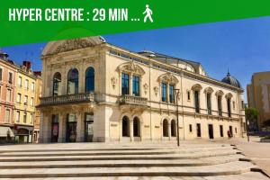 a large building with stairs in front of it at Ambiance moderne in Roanne