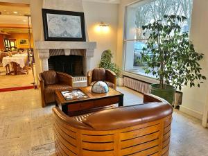 a living room with a couch and a fireplace at Logis Hôtel Le Rivage in Gien