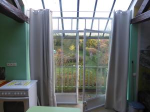 a kitchen with a window with a view of a garden at Les Buissonnets in Giverny