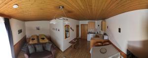 a view of a living room and kitchen with a ceiling at Pension Hintergarten in Oberzeiring