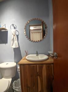 a bathroom with a sink and a toilet and a mirror at Hotel Dreimar in Cartagena de Indias