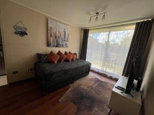 a bedroom with a bed and a large window at Departamento Park Collao Suit - Empresas Factura - Parking - wifi in Concepción