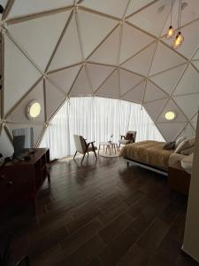 a tent with a bed and chairs in a room at El Gato Glamping con vista al valle in Huasca de Ocampo +32 photos