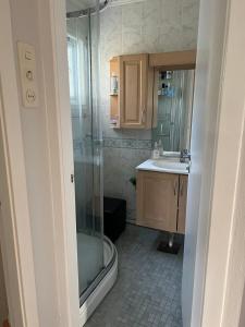 a bathroom with a shower and a sink at Guest room in private house in Ålesund