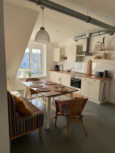 cocina con mesa y sillas en una habitación en Gemütliche Wohnung mit 2 Schlafzimmern auf 75 qm, en Kürnach