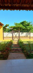 a gate in a garden with a fence at Casa de praia in Estância