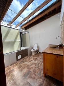 a bathroom with a sink and a toilet at Casa de eventos y descanso in La Calera
