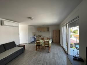 a living room with a couch and a table at Apartmani Tamaris in Murter
