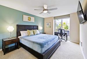 1 dormitorio con 1 cama, ventilador de techo y escritorio en Brooks Beach Vacations Villa C205 Oceanside, en Oceanside